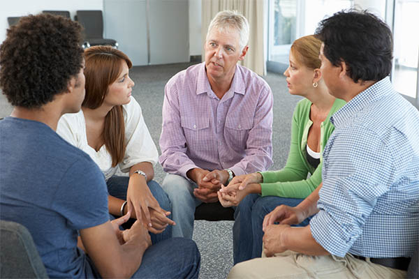 group therapy with five adults in circle